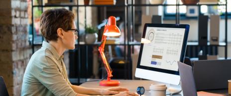 woman-analyzes-charts-and-graphs-at-modern-desk